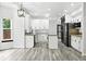 Bright kitchen features white cabinets, stainless steel appliances, and a large island at 2078 Goldfinch Ct, Longmont, CO 80503
