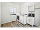 Functional laundry room includes a sink, cabinets, and modern washer and dryer at 2078 Goldfinch Ct, Longmont, CO 80503