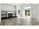 Bright living room features a fireplace, built-in shelves, and sliding glass doors at 2078 Goldfinch Ct, Longmont, CO 80503