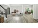 Bright living room featuring a gray sectional, wood floors, and an adjacent office space for comfortable living at 2078 Goldfinch Ct, Longmont, CO 80503
