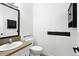 Stylish powder room featuring modern fixtures, a vanity, and a decorative mirror at 2078 Goldfinch Ct, Longmont, CO 80503