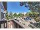 Balcony view overlooking parking lot with trees and beautiful blue skies at 7897 Allison Way # 304, Arvada, CO 80005