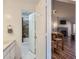 Bathroom view with the bathroom leading into a dining space and living room with fireplace at 7897 Allison Way # 304, Arvada, CO 80005