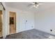 Bedroom leading to an ensuite bathroom with a white door and neutral carpet at 7897 Allison Way # 304, Arvada, CO 80005