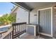 A unit entrance featuring a gray door and siding, with a small porch area at 7897 Allison Way # 304, Arvada, CO 80005