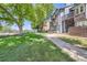 Well-maintained exterior featuring lush green grass, mature trees, and landscaped grounds at 7897 Allison Way # 304, Arvada, CO 80005