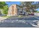 Exterior view of condo complex with surrounding greenery and ample parking spaces at 7897 Allison Way # 304, Arvada, CO 80005
