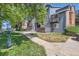 Apartment building exterior with well-maintained lawn and pet waste station by a walkway at 7897 Allison Way # 304, Arvada, CO 80005