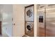 Stackable washer and dryer unit next to stainless steel refrigerator at 7897 Allison Way # 304, Arvada, CO 80005