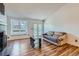 Bright living room with windows, patio access, and hardwood floors at 7897 Allison Way # 304, Arvada, CO 80005