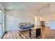 Bright living room featuring hardwood floors, a couch, and adjacent dining area at 7897 Allison Way # 304, Arvada, CO 80005