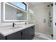 Spa bathroom with double vanity, modern shower, and led mirrors at 1252 Yates St, Denver, CO 80204