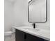 Sleek powder room features a black vanity, modern faucet and black framed mirror at 1252 Yates St, Denver, CO 80204