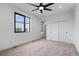 Bedroom featuring a ceiling fan, plush carpet and double-door closet at 1252 Yates St, Denver, CO 80204