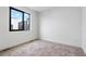Bedroom with large window for plenty of natural light and neutral carpet at 1252 Yates St, Denver, CO 80204