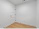 Bright bedroom with neutral walls, hardwood floors, and a door to the hall at 1252 Yates St, Denver, CO 80204