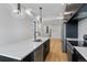 Modern kitchen features stainless steel appliances, quartz countertops and hardwood floors at 1252 Yates St, Denver, CO 80204