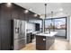 Well-equipped kitchen featuring an island with a sink, modern cabinets, and stainless steel appliances at 1252 Yates St, Denver, CO 80204