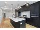 Contemporary kitchen showcasing a center island with a sink and stainless steel appliances at 1252 Yates St, Denver, CO 80204