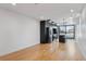 Modern kitchen with sleek black cabinetry, stainless steel appliances, and hardwood floors at 1252 Yates St, Denver, CO 80204
