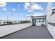 Rooftop deck features durable gray flooring and stunning city views at 1252 Yates St, Denver, CO 80204