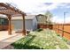 Backyard featuring a pergola, small garage and well maintained lawn at 2869 Kingston St, Denver, CO 80238