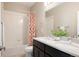 Well-lit bathroom featuring a double sink vanity, shower, and modern fixtures at 2869 Kingston St, Denver, CO 80238