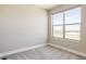 Carpeted bedroom with a large window showcasing outdoor views and ample natural light at 2869 Kingston St, Denver, CO 80238