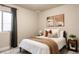 Well-lit bedroom with modern decor, cozy blankets, and stylish throw pillows at 2869 Kingston St, Denver, CO 80238