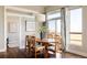 Dining area with a wood table, modern light fixture, and sliding glass doors to the outside at 2869 Kingston St, Denver, CO 80238