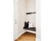 Cozy entryway with a built-in bench, decorative pillows, and hooks for coats, providing a welcoming space at 2869 Kingston St, Denver, CO 80238