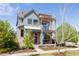 Charming two-story home featuring a pergola, well-maintained front yard and blue exterior paint at 2869 Kingston St, Denver, CO 80238
