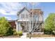 Charming two-story home with a covered porch, landscaped yard, and inviting curb appeal at 2869 Kingston St, Denver, CO 80238