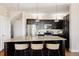 Stylish kitchen featuring a granite island with seating and stainless steel appliances at 2869 Kingston St, Denver, CO 80238