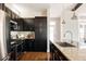 Well-equipped kitchen with dark wood cabinets, granite countertops, and stainless steel appliances at 2869 Kingston St, Denver, CO 80238
