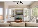 Bright and airy living room with built-in shelving, a modern fireplace, and large windows at 2869 Kingston St, Denver, CO 80238