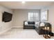 Cozy living room with a large sectional sofa, modern decor, and a mounted TV at 2869 Kingston St, Denver, CO 80238
