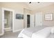 Spacious main bedroom featuring a TV, ensuite bathroom access, and serene decor, offering ultimate comfort at 2869 Kingston St, Denver, CO 80238