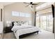 Serene main bedroom with large windows, plush bedding, and stylish nightstands for a relaxing retreat at 2869 Kingston St, Denver, CO 80238