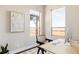 Bright home office featuring a modern desk, stylish chair, and large windows offering ample natural light at 2869 Kingston St, Denver, CO 80238