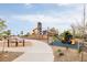 Community playground with slides, climbing structures, and soft landing surfaces at 2869 Kingston St, Denver, CO 80238