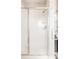 Clean, bright shower with white tile, modern fixtures, and a glass door, providing a refreshing space at 2869 Kingston St, Denver, CO 80238