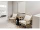 Inviting sitting area with comfortable chairs and a small table, creating a perfect spot for relaxation at 2869 Kingston St, Denver, CO 80238