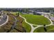 The community park features open green spaces, walking paths, a stream, and mature landscaping at 6705 Nelson St, Arvada, CO 80004