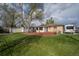Backyard featuring a brick patio, shed, lawn, and RV parking with a large tree providing shade at 6705 Nelson St, Arvada, CO 80004