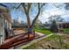 Backyard featuring a brick deck, seating, lawn, and a large tree providing shade at 6705 Nelson St, Arvada, CO 80004