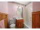 Compact bathroom featuring wood paneling, a floral border, and a shower-tub combination at 6705 Nelson St, Arvada, CO 80004