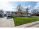 A charming one-story brick house with a well-kept lawn and an RV on the driveway at 6705 Nelson St, Arvada, CO 80004