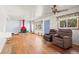 Bright living room with hardwood floors, a red fireplace, and two armchairs at 6705 Nelson St, Arvada, CO 80004