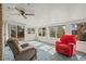 Bright sunroom with large windows, a ceiling fan, and two comfortable armchairs at 6705 Nelson St, Arvada, CO 80004